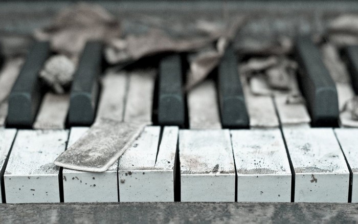 Close up of broken piano keys covered in dust