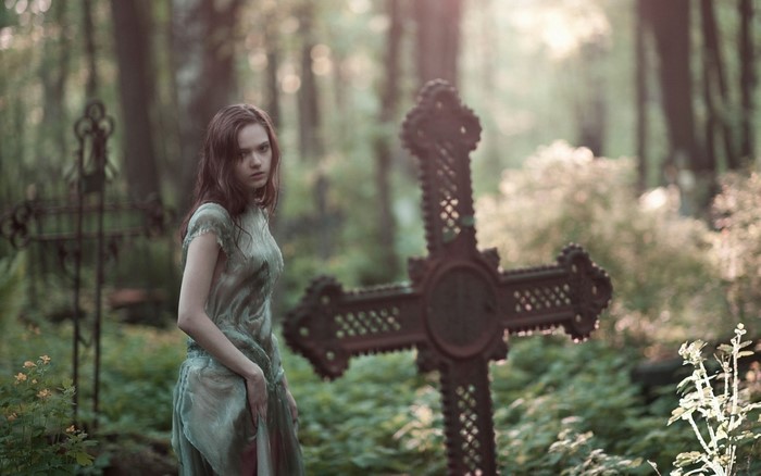 Woman in a graveyard with crosses