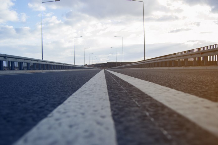 Road with double white lines and streetlights
