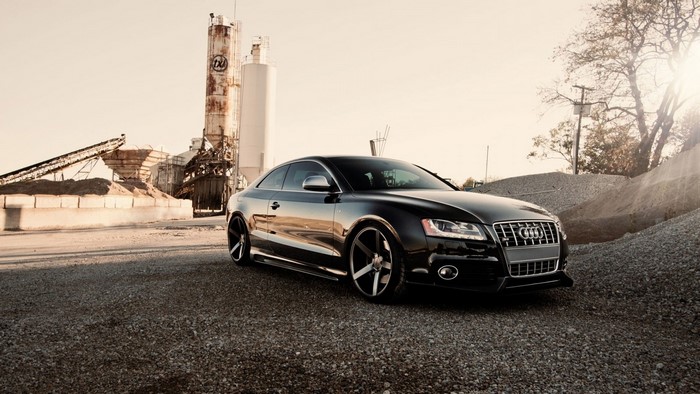 Black Audi S5 Coupe at an industrial site