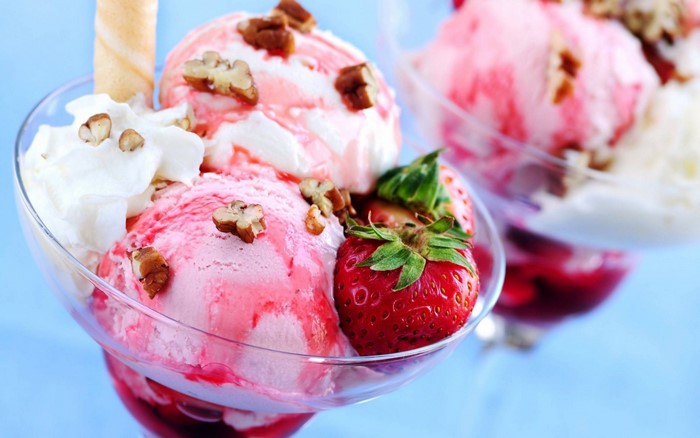 Strawberry ice cream sundae with whipped cream and nuts