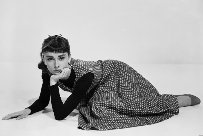 Audrey Hepburn posing in a patterned dress