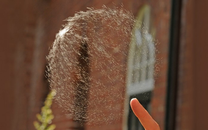 Close-up of water splashes near a finger