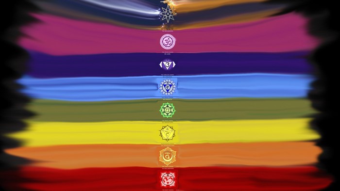 Seven Chakras with Om Symbol and Rainbow Background