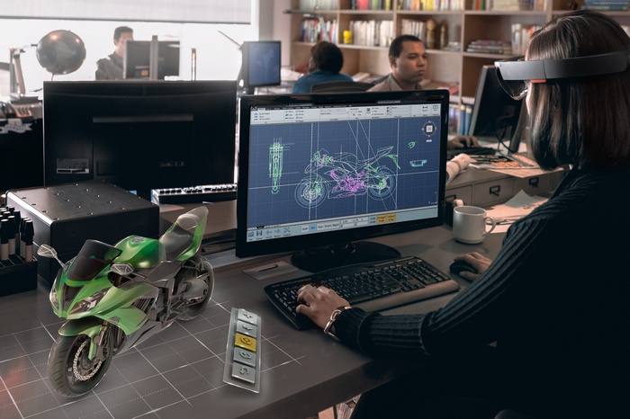 Woman using Microsoft HoloLens with motorcycle design on screen
