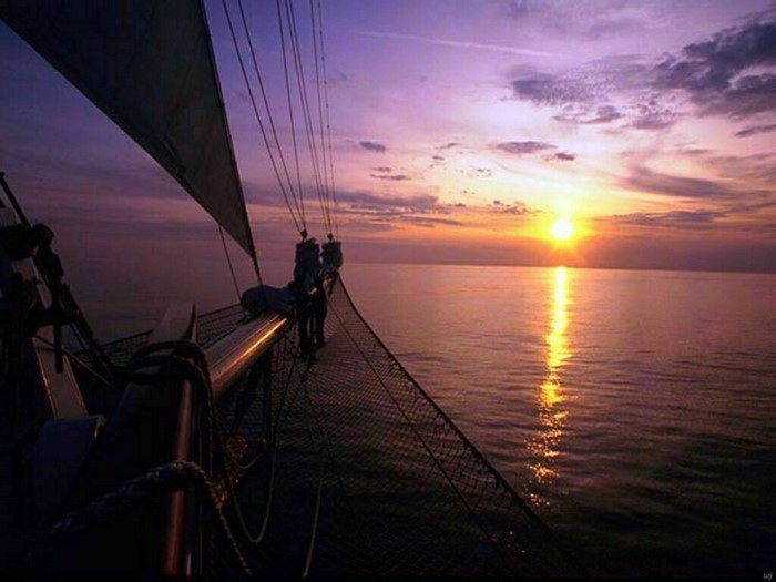 Sailboat sailing on the ocean at sunset