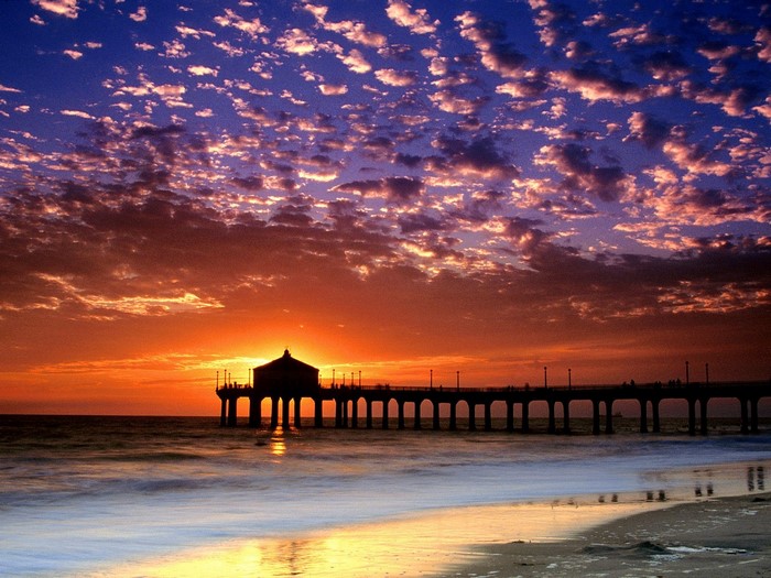 Sunset over the ocean with a pier