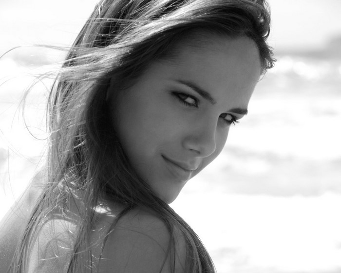 Woman with long brown hair looking over her shoulder
