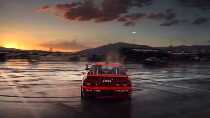 Red drift car on wet asphalt at sunset
