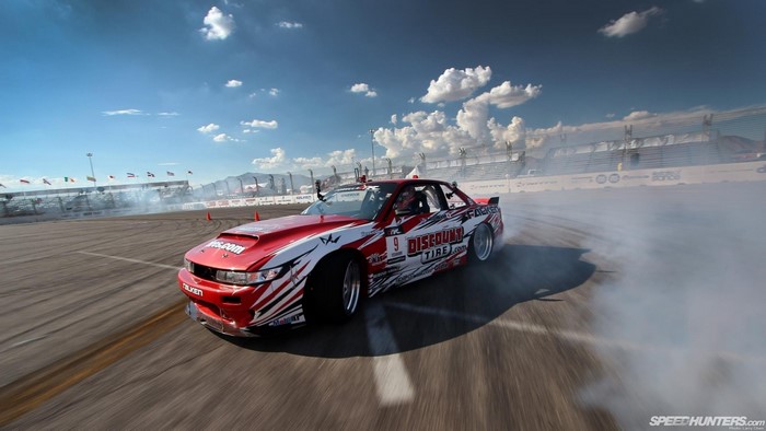 Red and white drift car on a race track