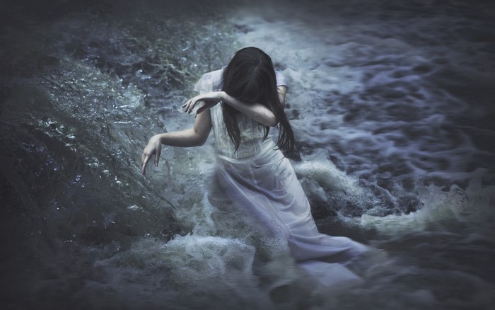 Woman in white dress in turbulent water