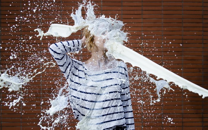 Woman with milk splashed on her face