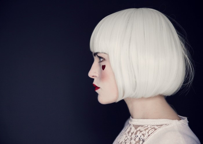 Woman with white bob wig and heart makeup