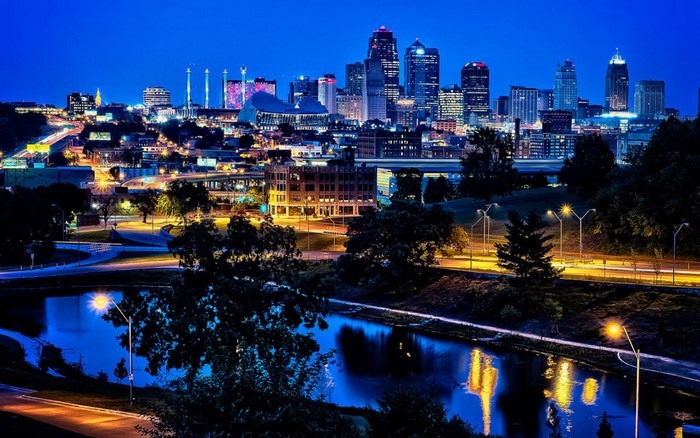 Kansas City skyline at dusk with reflections in water