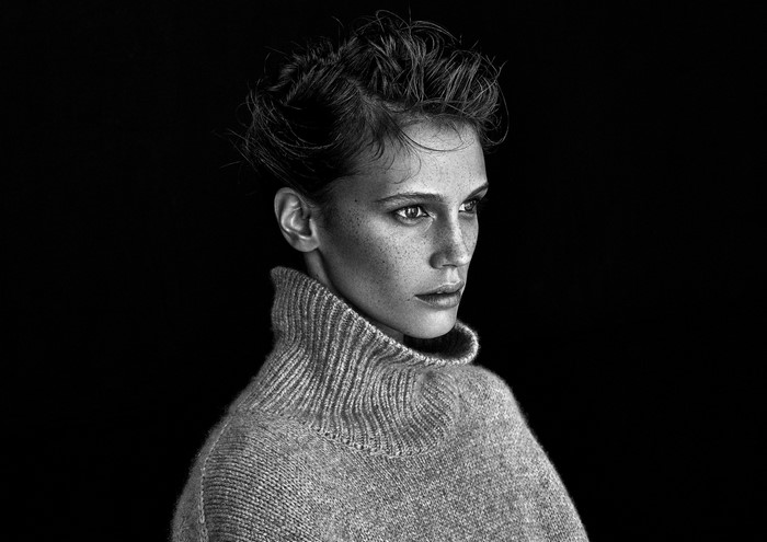 Monochrome portrait of a woman with freckles wearing a turtleneck