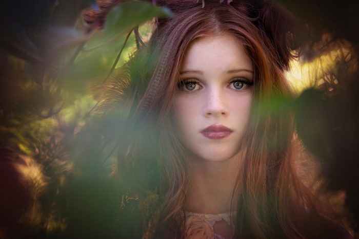 Portrait of a young woman with red hair and blue eyes