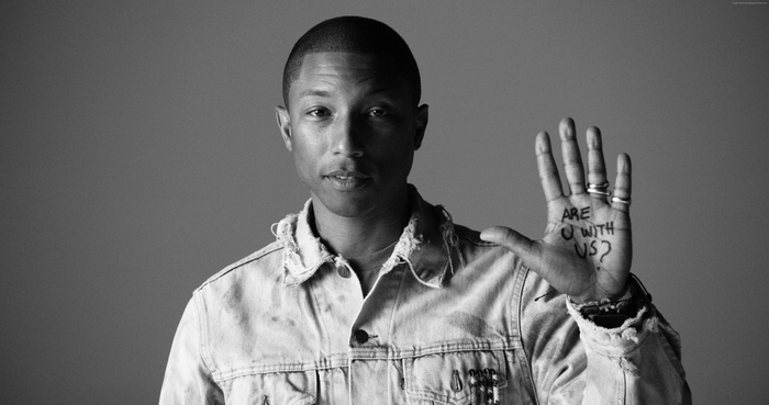 Pharrell Williams with text on hand