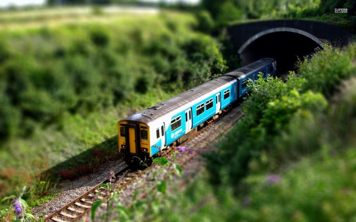 Blue and yellow train entering a tunnel