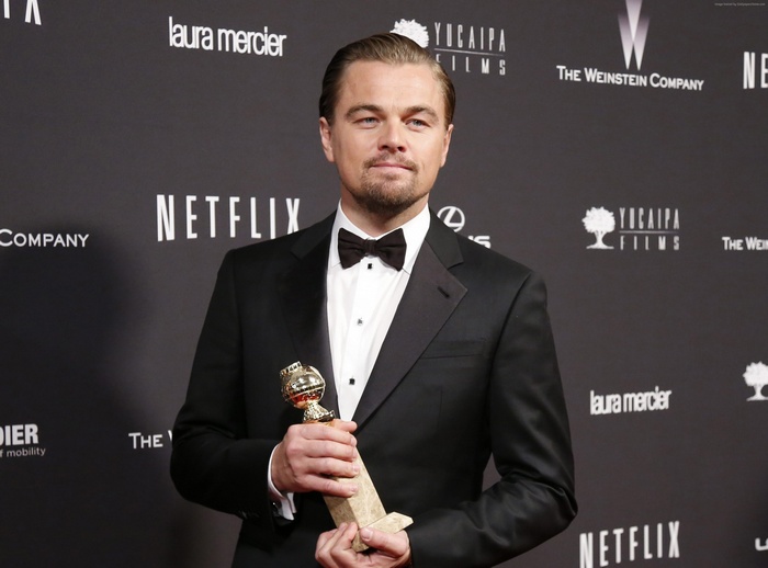 Leonardo DiCaprio holding a Golden Globe award