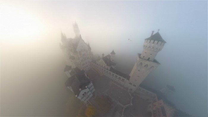 Neuschwanstein Castle in fog, aerial view