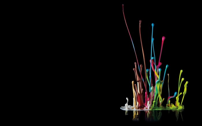 Colorful paint splashes on a black background