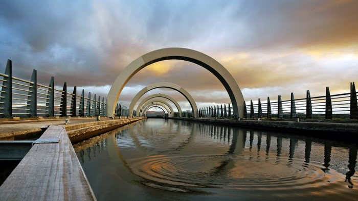 The Falkirk Wheel canal boat lift at sunset