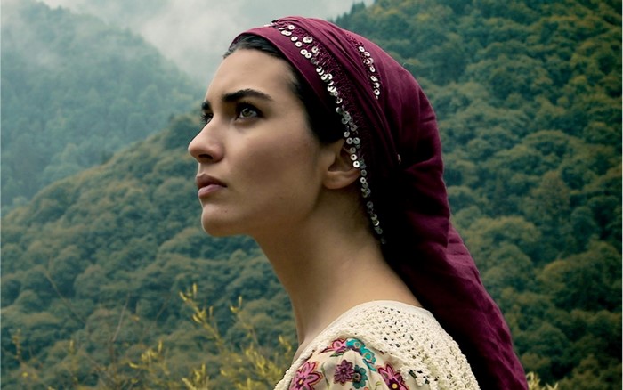 Woman wearing a headscarf in a forest