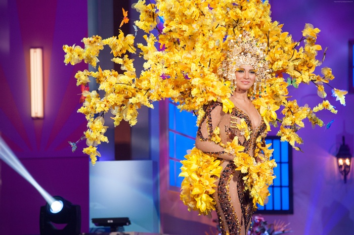 Migbelis Castellanos in a yellow floral national costume