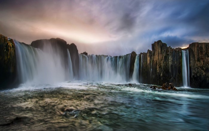 Waterfall cascading over rocks into a body of water