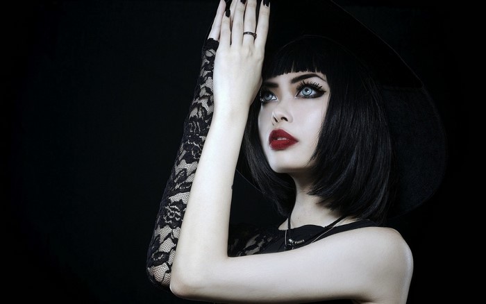 Woman with black bob wig and gothic makeup