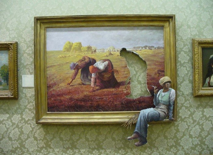 Woman sitting on a painting in a gallery