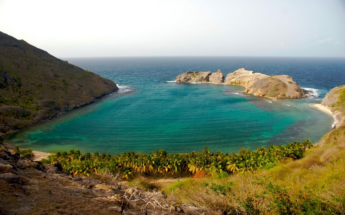 Tropical bay with rocky islands and palm trees