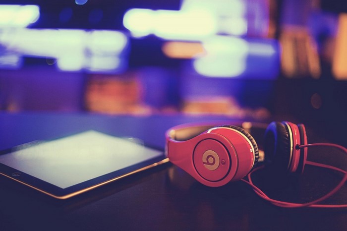 Red Beats by Dre headphones and tablet