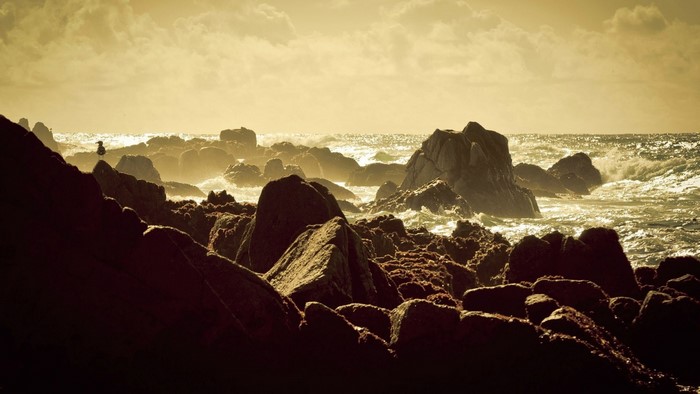 Rocky coast with waves at sunset