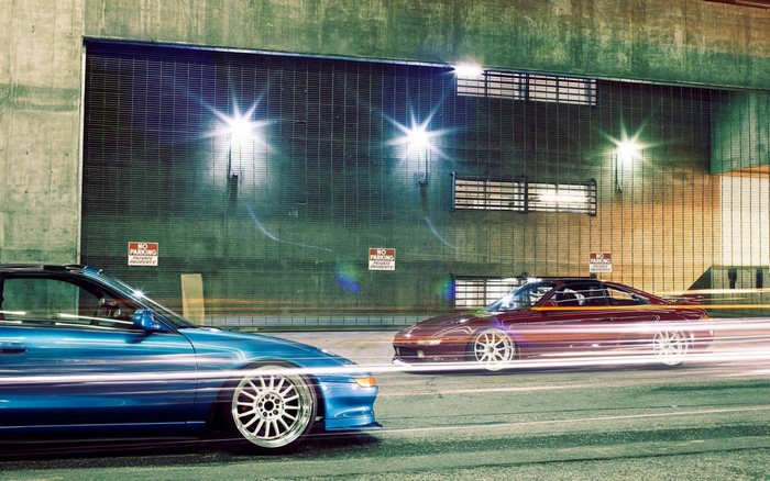 Blue and red Toyota MR2 cars driving at night