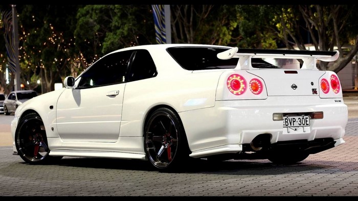 White Nissan Skyline GT-R R34 V Spec II with spoiler