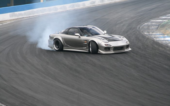 Silver Mazda RX-7 Drifting on a Race Track