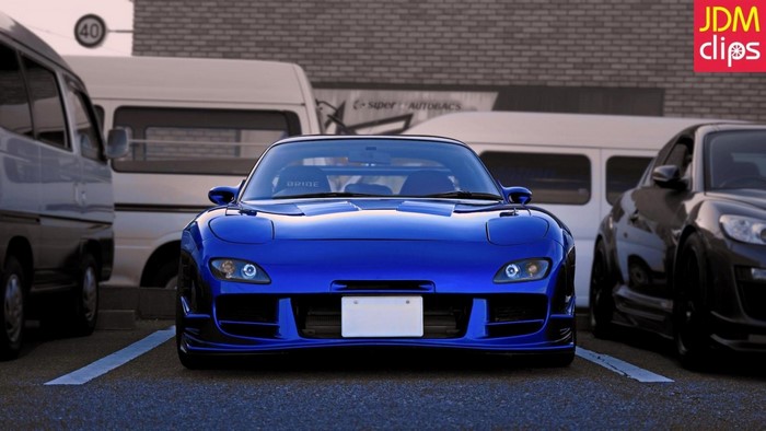Blue Mazda RX-7 FD parked with other vehicles