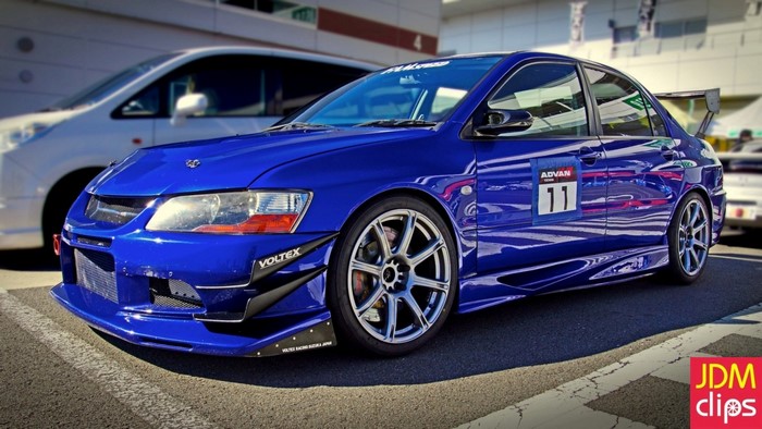 Blue Mitsubishi Lancer Evolution IX with racing decals