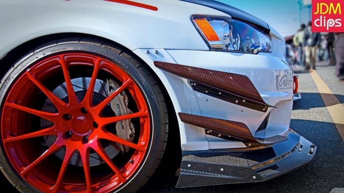 White Mitsubishi Lancer Evolution X with red rims