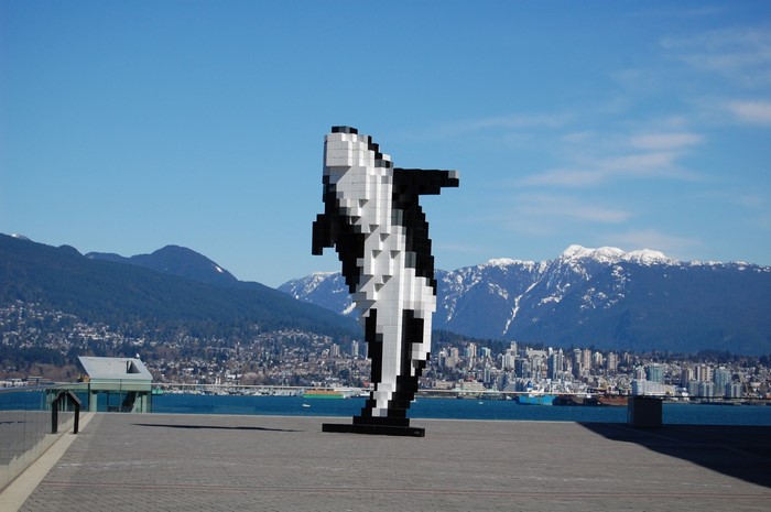 Pixel art orca sculpture with Vancouver skyline and mountains