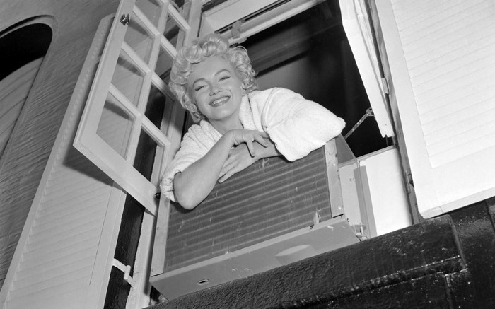 Marilyn Monroe leaning out of a window