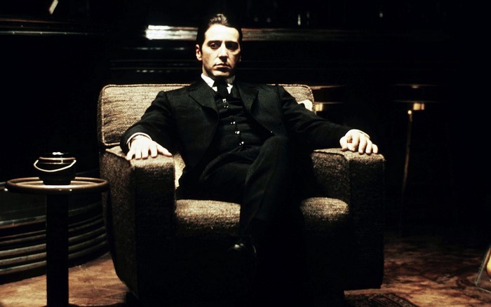 Michael Corleone from The Godfather sitting in a chair