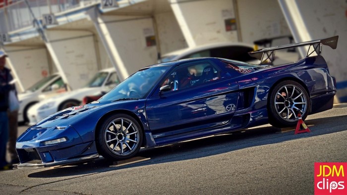 Blue Honda NSX sports car with large rear spoiler