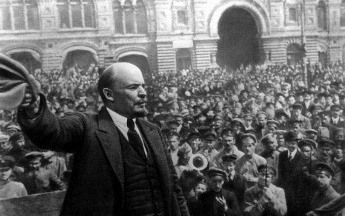 Vladimir Lenin addressing a crowd in front of a building