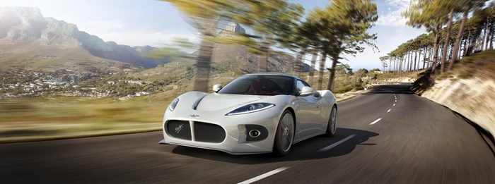 White Spyker B6 Venator driving on a scenic road