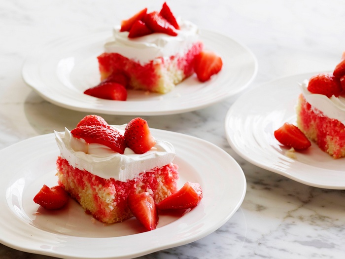 Strawberry cake slices with whipped cream and strawberries