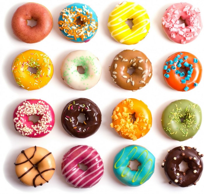 Assortment of colorful donuts with various toppings