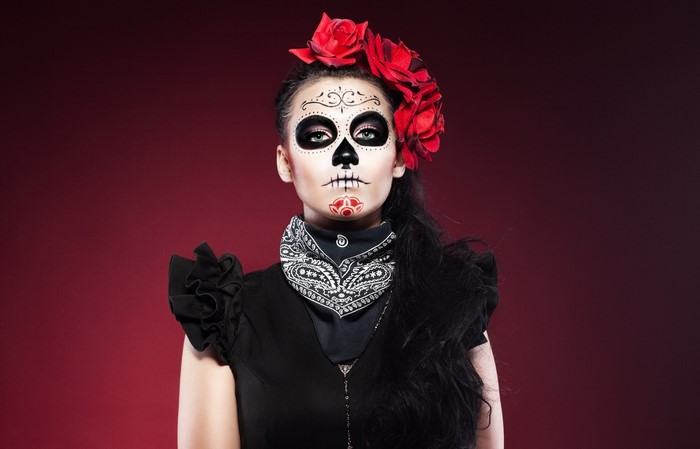 Woman with Sugar Skull makeup and red roses