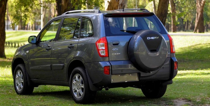 Chery Tiggo crossover SUV parked on grass